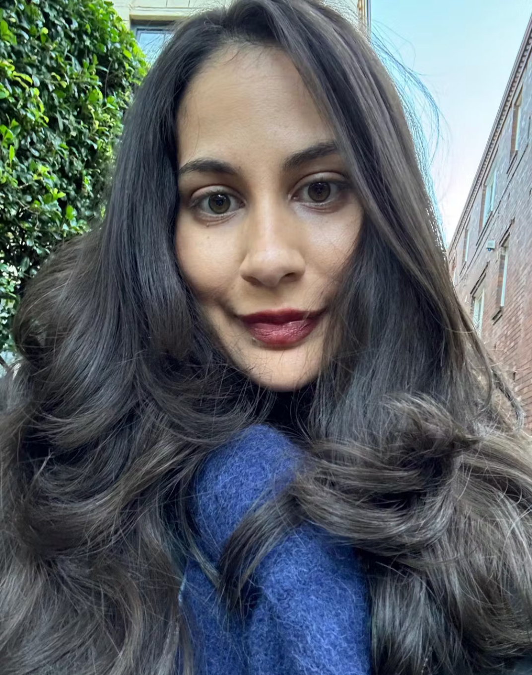 A DCS customersshows her soft curls on long hair